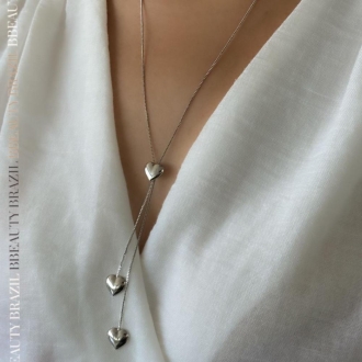 Detalhes do produto Colar gravata com três corações lisos, em ródio.